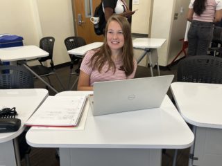 A n HSJI student smiles as they work on their computer