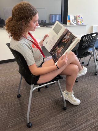 A student reads through a yearbook