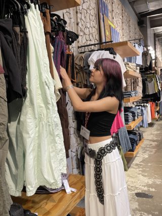 A person browses for clothing at Urban Outfitters on Kirkwood Avenue