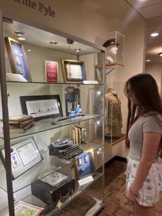 Senior Scarlett Irwin observes the Purple Heart Medal of Ernie Pyle in the display case. Irwin is attending HSJI, taking the Yearbook workshop centered at Franklin Hall in IU Bloomington