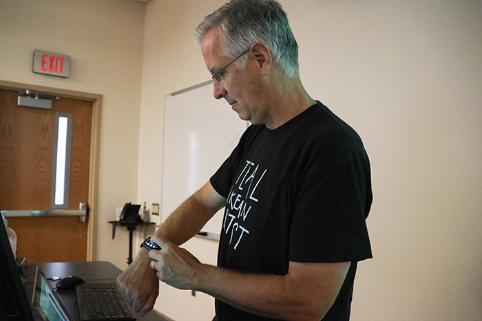 Professor Glennon focused on his Apple Watch