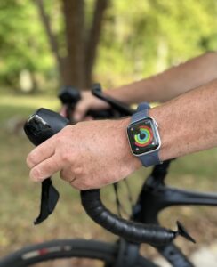 Man using his Apple Watch to track his workout on the bike. 