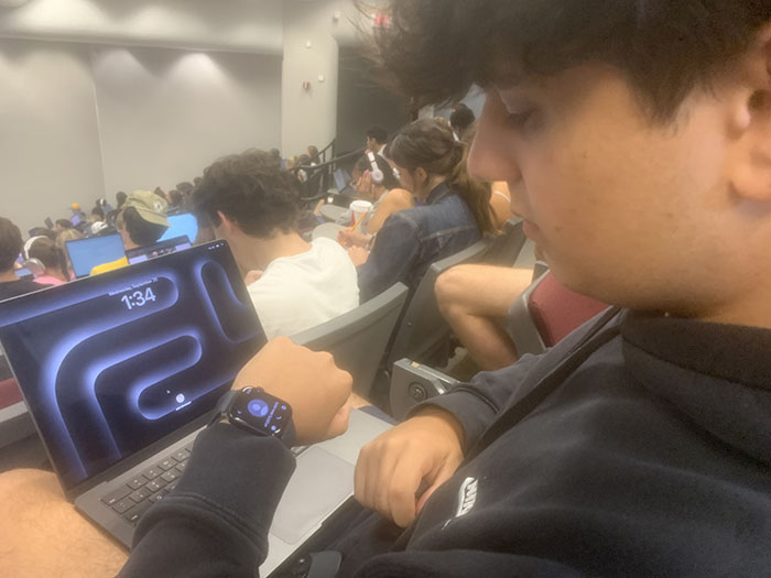 College student checking an Apple Watch in class