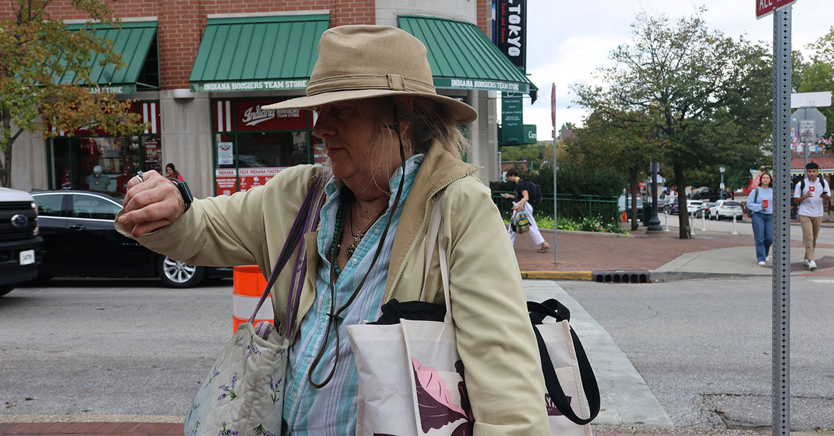 Older Woman checks Apple Watch while shopping on Kirkwood.