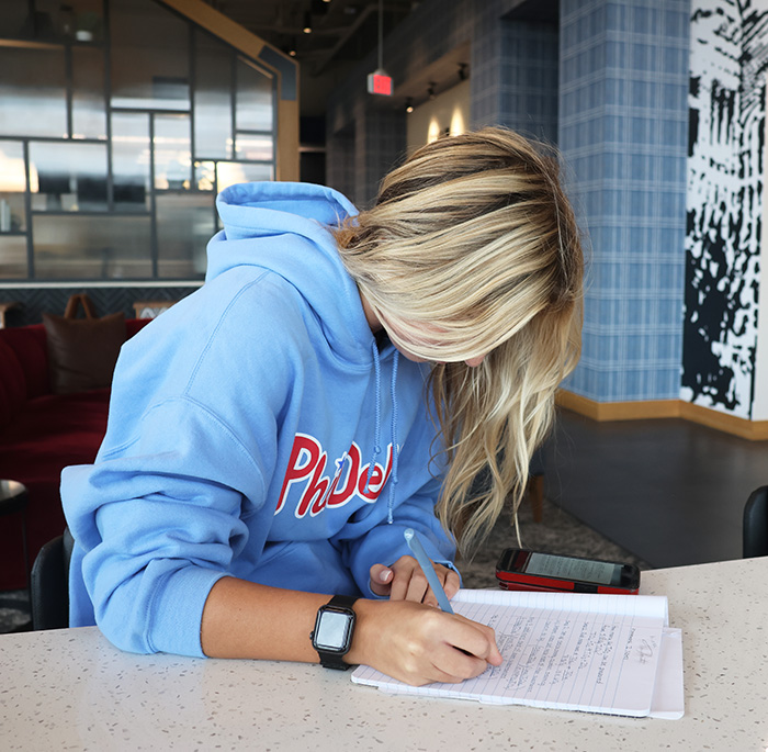 Ava Cornette doing homework while wearing the Apple Watch 