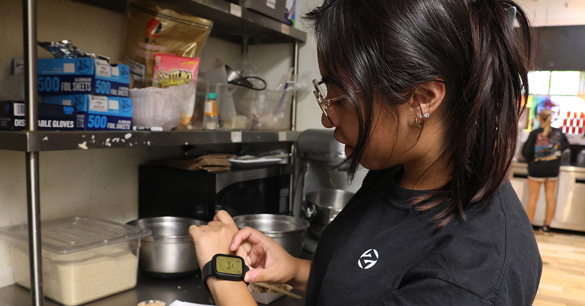 A young women uses the timer application on her Apple Watch.