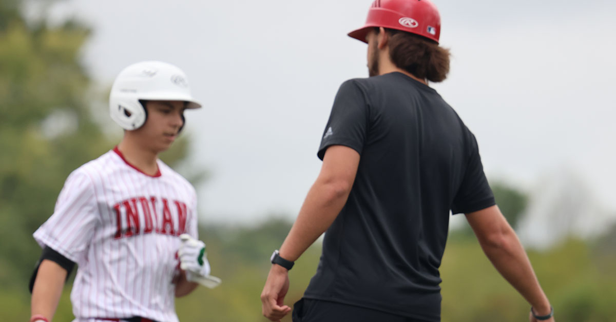 Baseball player trying out the new Apple Watch