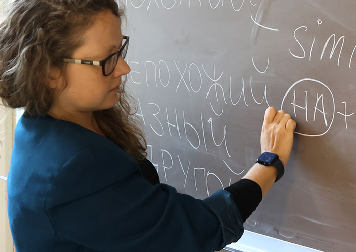 Woman wearing Apple Watch while teaching Russian class 