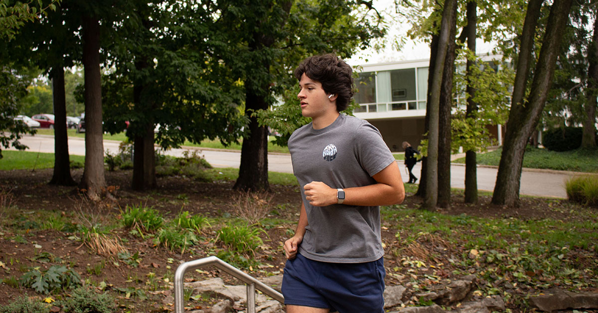 man running with apple watch on