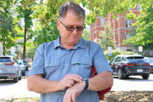 A man on the IUB campus uses his Apple Watch