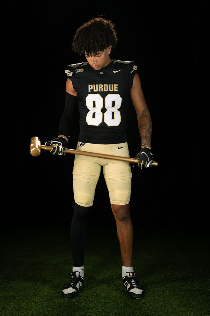 Football player holds hammer