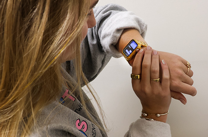 Girl is using her Apple Watch to send a voice text message.