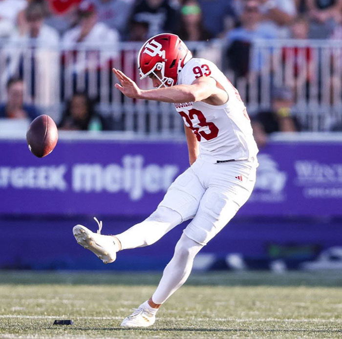 Quinn Warren, freshman quicker on the Indiana University Football Team, punts the football during an electric game. 