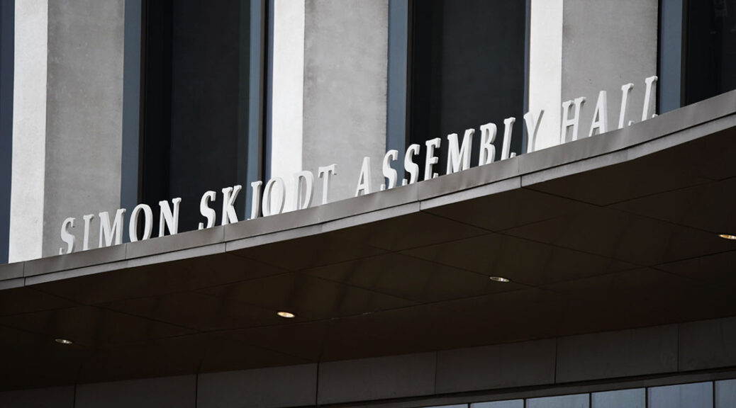 Sign above doors of Simon Skjodt Assembly Hall on the Bloomington campus of Indiana University.