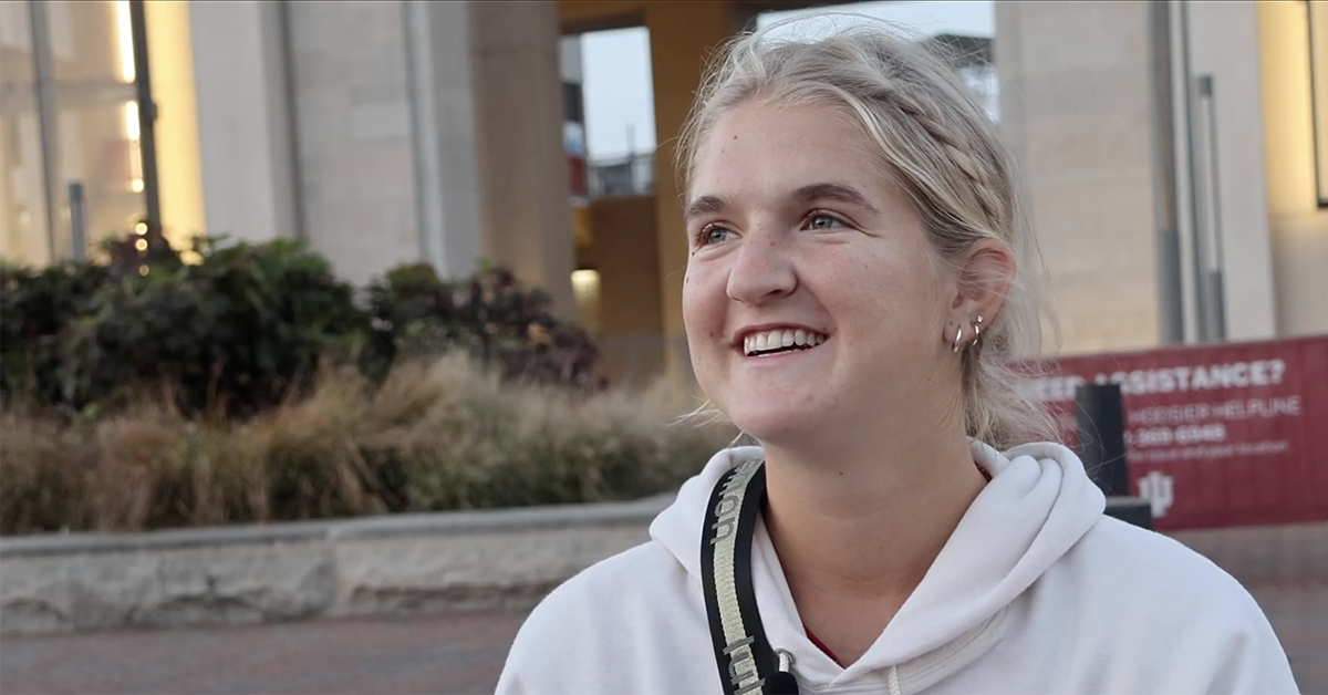 a young woman on the tennis team smiling 