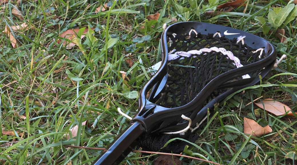 Lacrosse Stick laying on grass