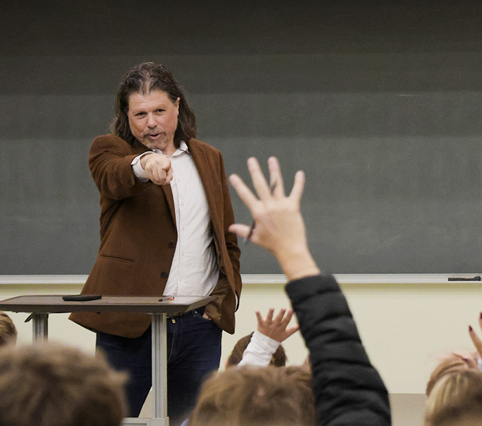 Associate Dean for Undergraduate Education for the Media School Dr. Galen Clavio points to a student with his hand up.