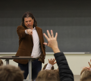 Associate Dean for Undergraduate Education for the Media School Dr. Galen Clavio points to a student with his hand up.