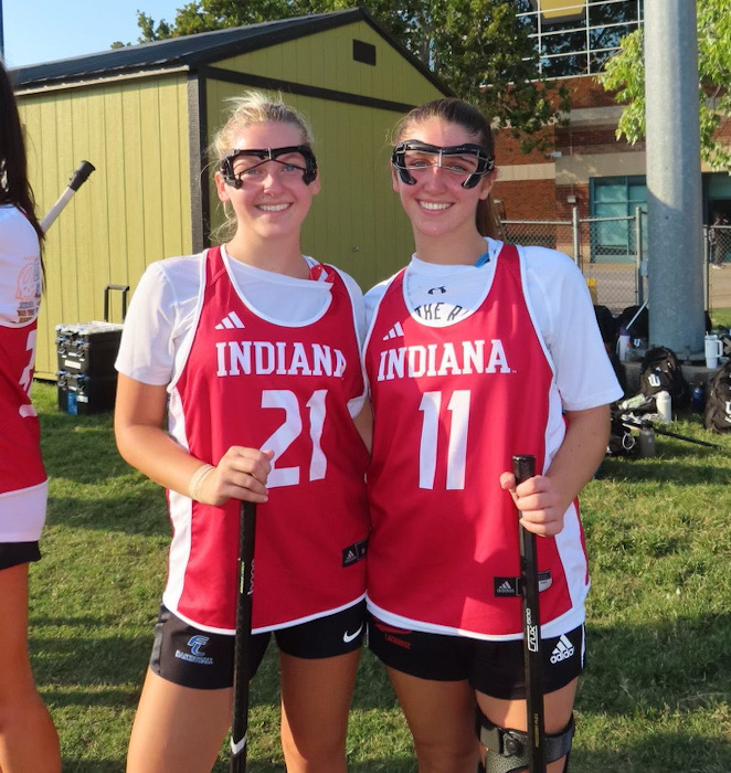 2 players on the womens lacrosse team at Indiana University pose post game.