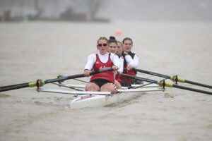 Ara Cowper and the Indiana Rowing team competing on a cloudy misty day in Bloomington.