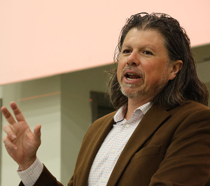 Dr. Galen Clavio speaks to a classroom at a "press conference."