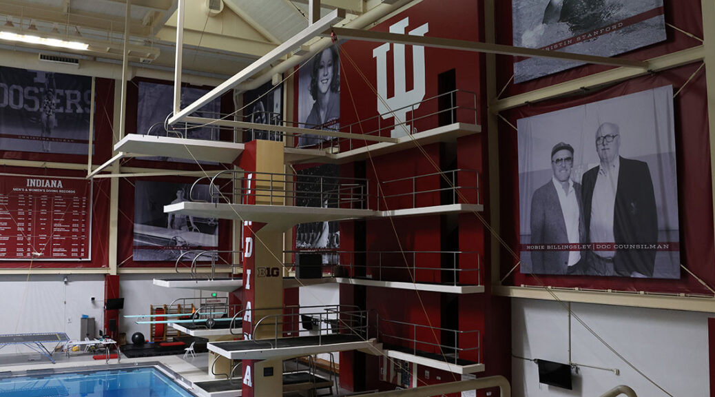 Posters and the IU symbol line the walls behind the diving boards at IU's pool.