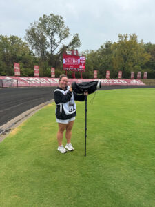 Grace Urbanski shown photographing for Indiana Athletics on a rainy day