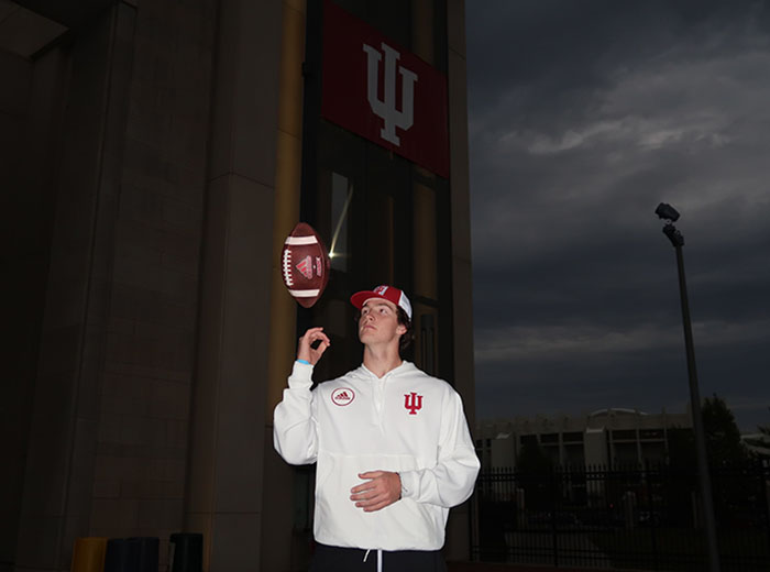 Tyler Cherry tossing a football up in the air