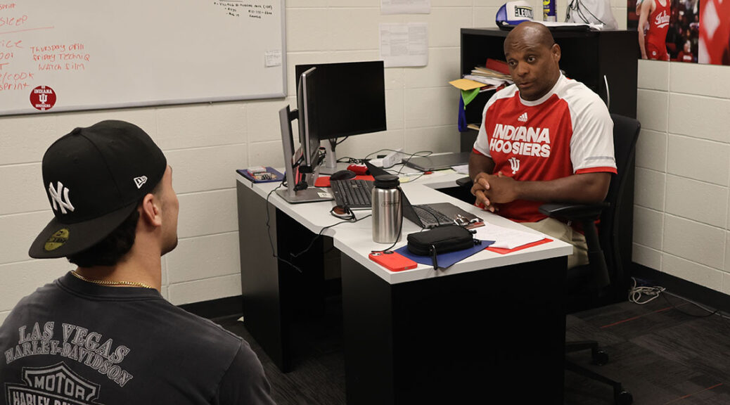 Coach Mike Dixon talks with wrestler at Indiana University