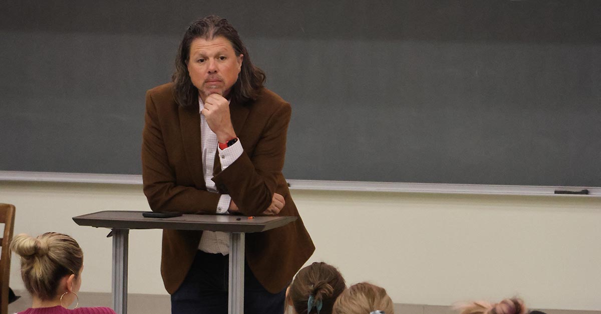 Professor Galen Clavio standing looking intensely at a press conference