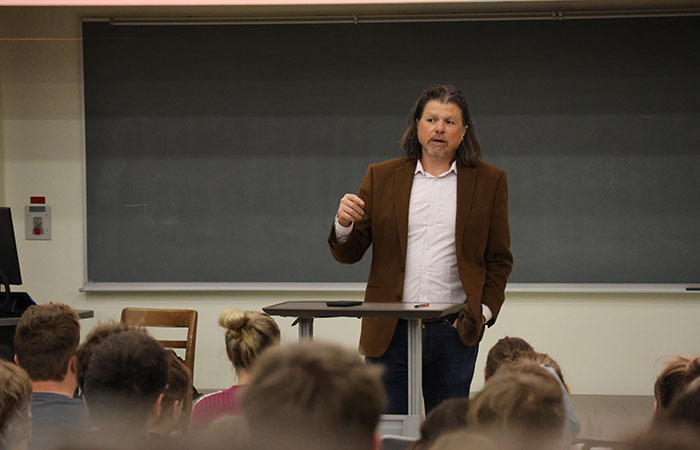 Professor Clavio guest lecturing a room full of students