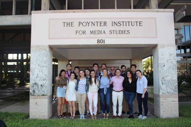 Ernie Pyle Scholars pose in front of the entrance to the Poynter Instiute for Media Studies