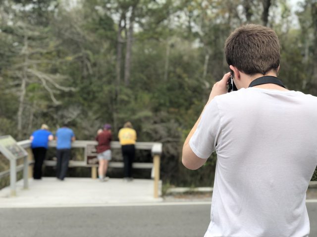 Spencer Bowman takes a photo of some park tourists.
