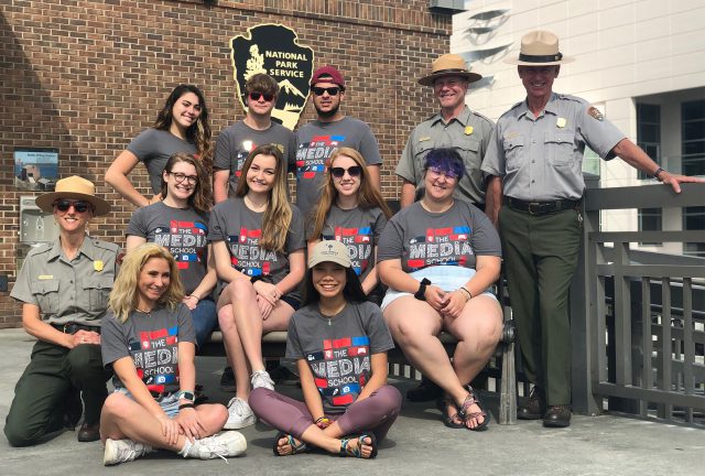 The alternative summer break group poses with park rangers in front of Fort Sumter national monument.