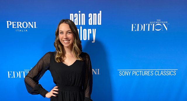 Olivia Cohn in front of a step-and-repeat backdrop that says "Pain and Glory," "Peroni," "The West Hollywood Edition" and "Sony Pictures Classics"
