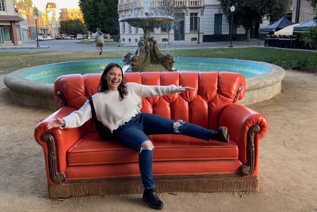 Sky Blanton poses on a couch from "Friends."