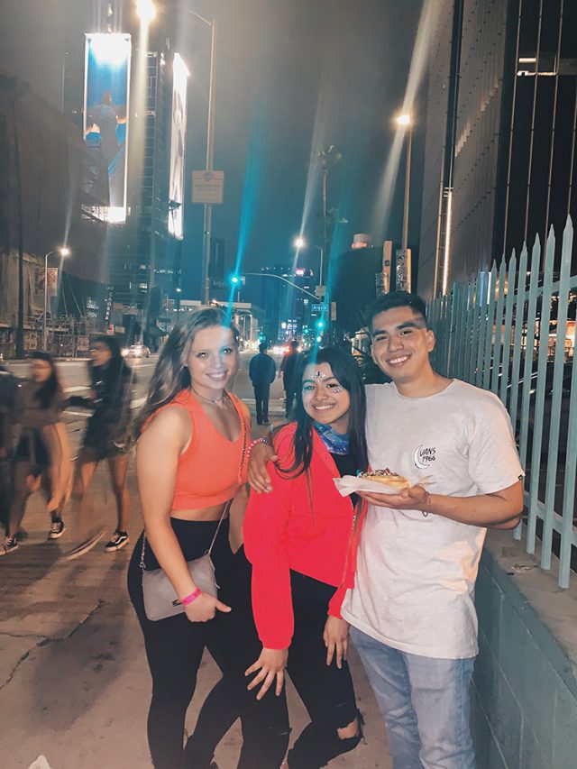 Three students on a street in L.A. at night
