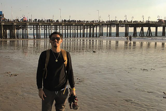 Victor Ramirez Cruz standing in front of a pier