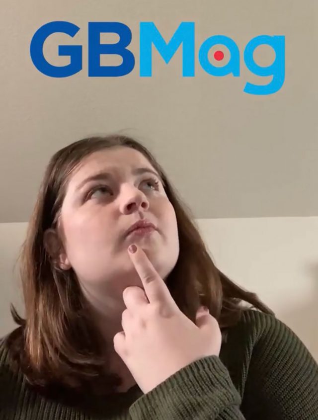 A woman holding a finger up to her chin with the words "GBMag" above.