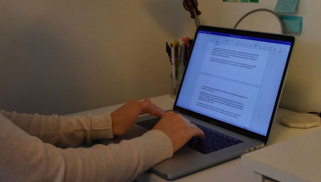 A person typing on a laptop