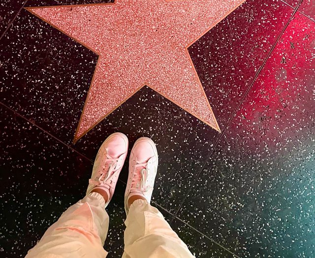 Feet in front of a Hollywood Boulevard star