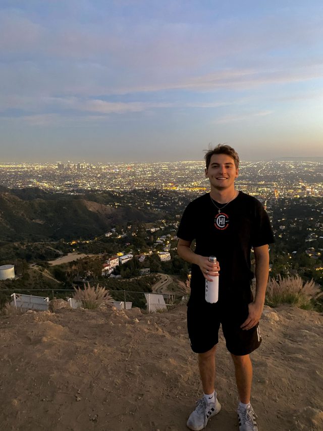 Nathan Previs poses on top of Mount Hollywood
