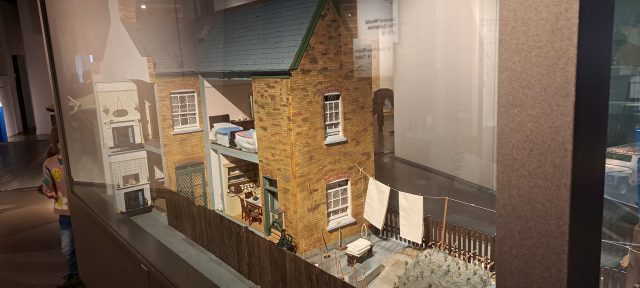 a museum exhibit features a small model house showing what a 1941 London home might look like